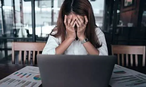 Stressed woman at laptop