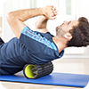 Exercising with foam roller on mat
