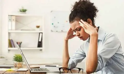 Tired woman in office setting