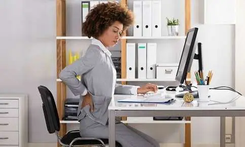 Employee holding back in office chair