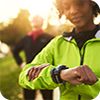 Woman in green jacket with smartwatch