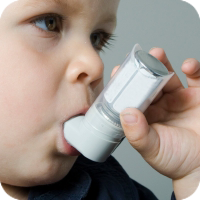 Young boy inhaling medicine