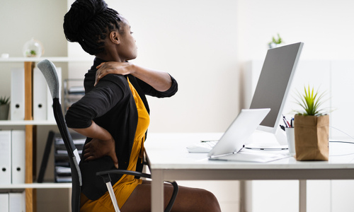 Woman stretching at desk