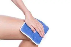 Applying cold compress to knee
