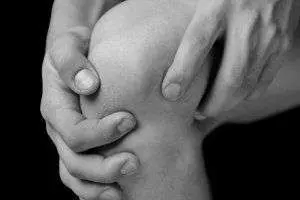 Grasping knee in discomfort
