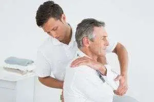 Physiotherapist treating shoulder pain
