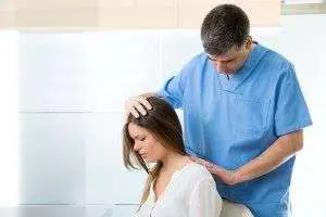 Healthcare professional treating woman's spine