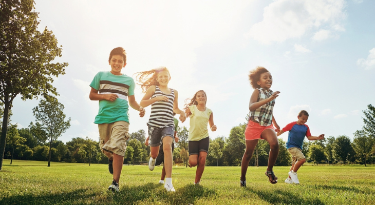 Group of kids sprinting on grass