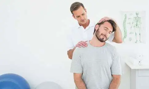Man receiving neck treatment in clinic