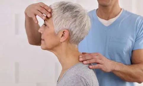 Senior woman receiving neck treatment