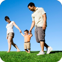Happy family stroll on sunny day.