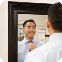 Smiling man in mirror reflection