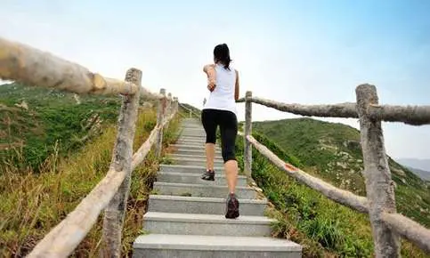 Woman running up outdoor stairs