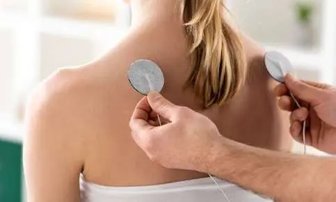Therapist applying electrode pads