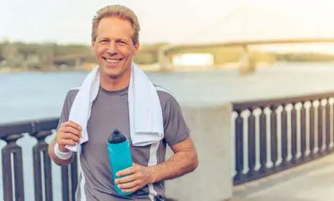 Man jogging with water bottle outdoors