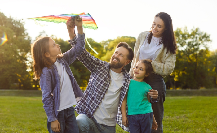 Family flying kite in the park