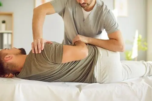 Therapist assisting with back alignment