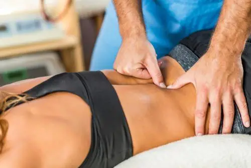 Chiropractor performing back adjustment