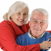 Elderly pair wearing red and blue sweaters