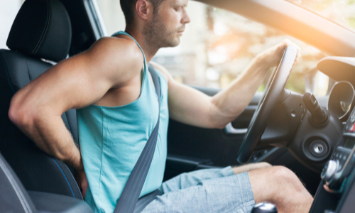 Driver experiencing back pain while driving