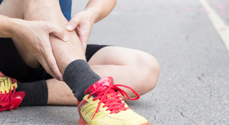 Person sitting with leg injury