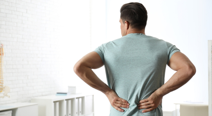 Person with backache indoors