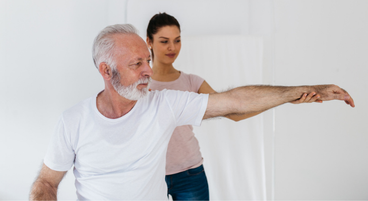 Elderly man doing arm exercises