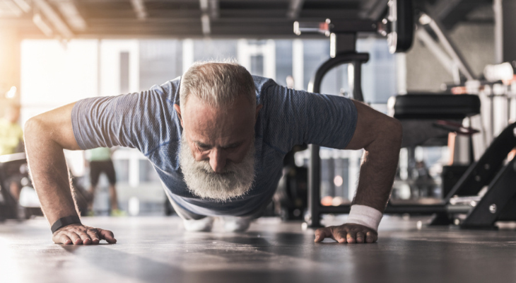 Elderly man exercising indoors