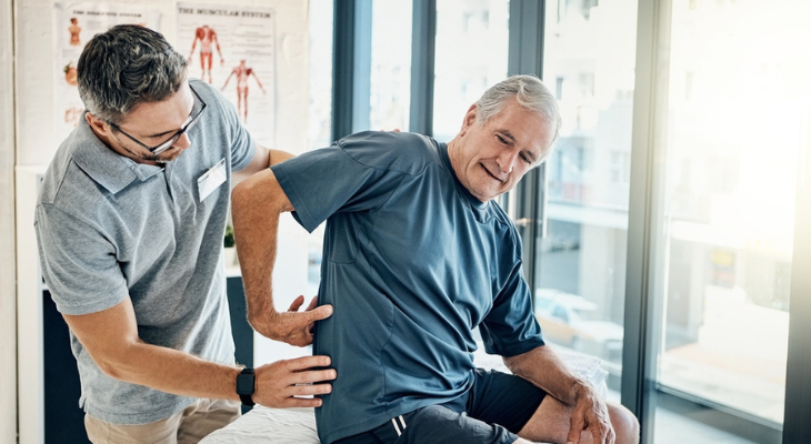Senior receiving back therapy