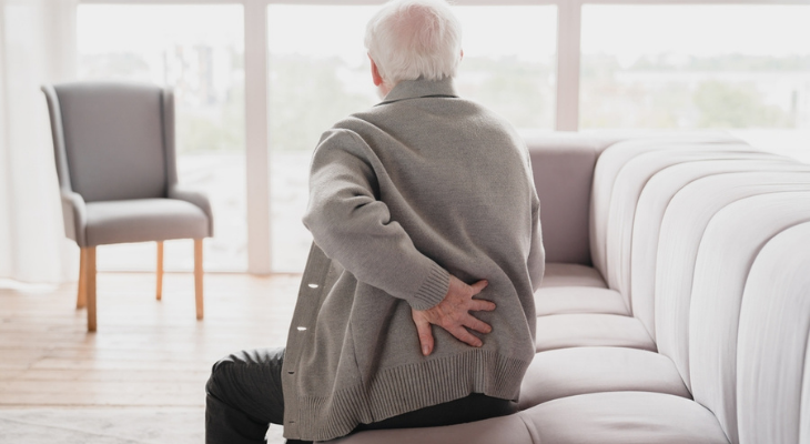 Man experiencing backache while seated.