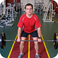 Man lifting barbell in gym