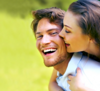 Woman playfully hugging smiling man
