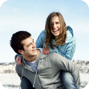 Joyful pair laughing in the snow.
