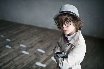 Child detective with magnifying glass