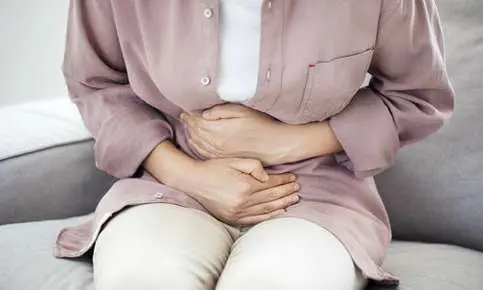 Woman experiencing abdominal pain