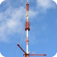 Tall communication tower with clouds