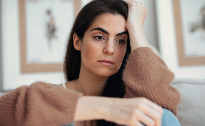 Contemplative expression on woman's face at home