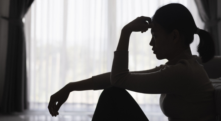 Contemplative silhouette against a bright window