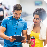 Gym trainer consulting with a client