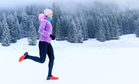 Athlete jogging through snow-covered forest