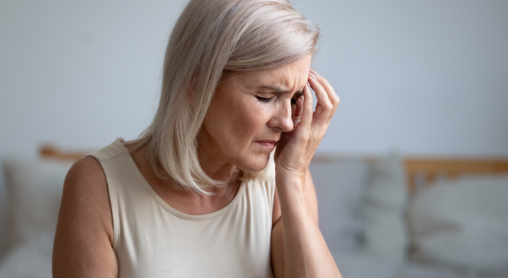 Senior woman holding her head