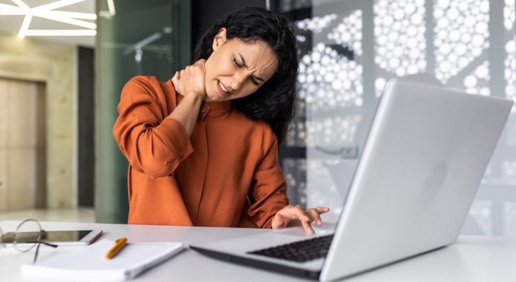 Person massaging neck while working