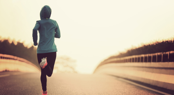 Jogger in blue hoodie at sunrise