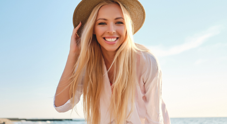 Woman smiling on sunny beach