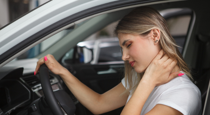 Driver holding neck uncomfortably
