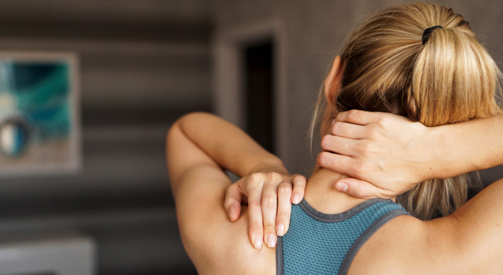 Woman massaging her neck and shoulder