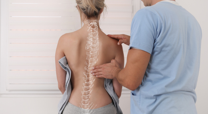 Back examination with spine illustration overlay