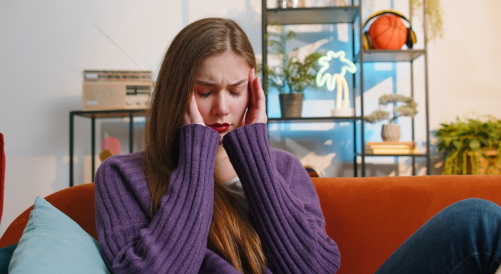 Young woman holding head in frustration