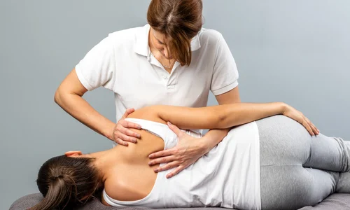Woman receiving spinal alignment treatment