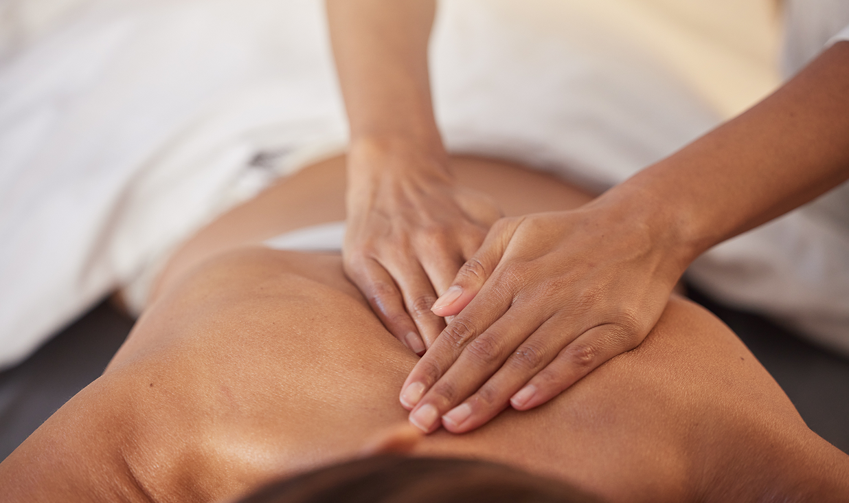 Massage therapist working on client's back